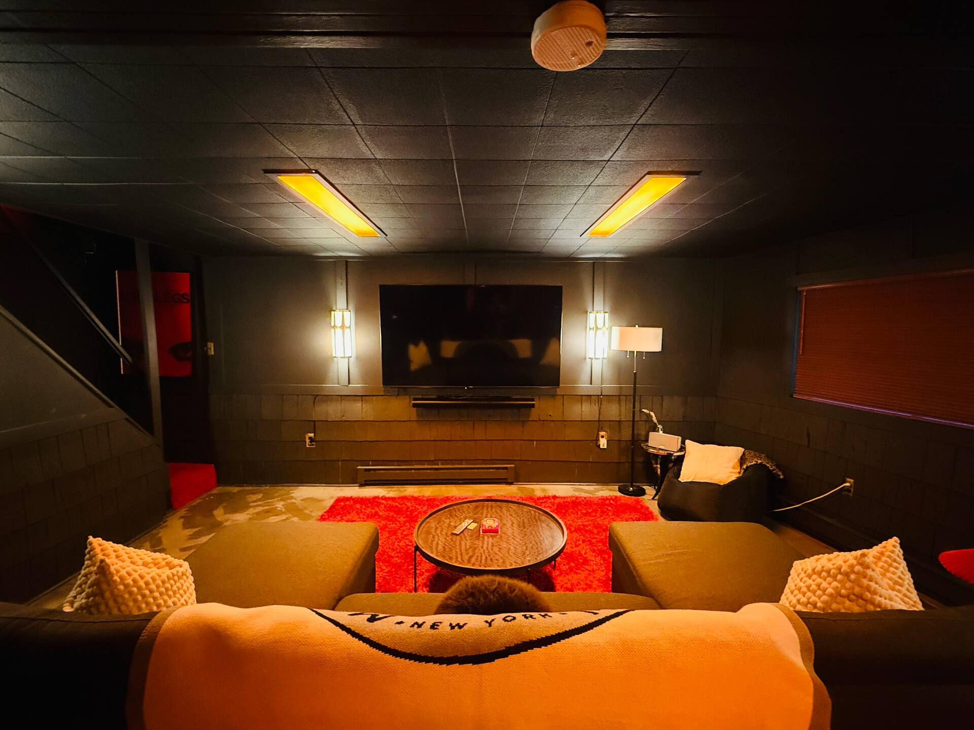 Basement home theater with sectional and screen