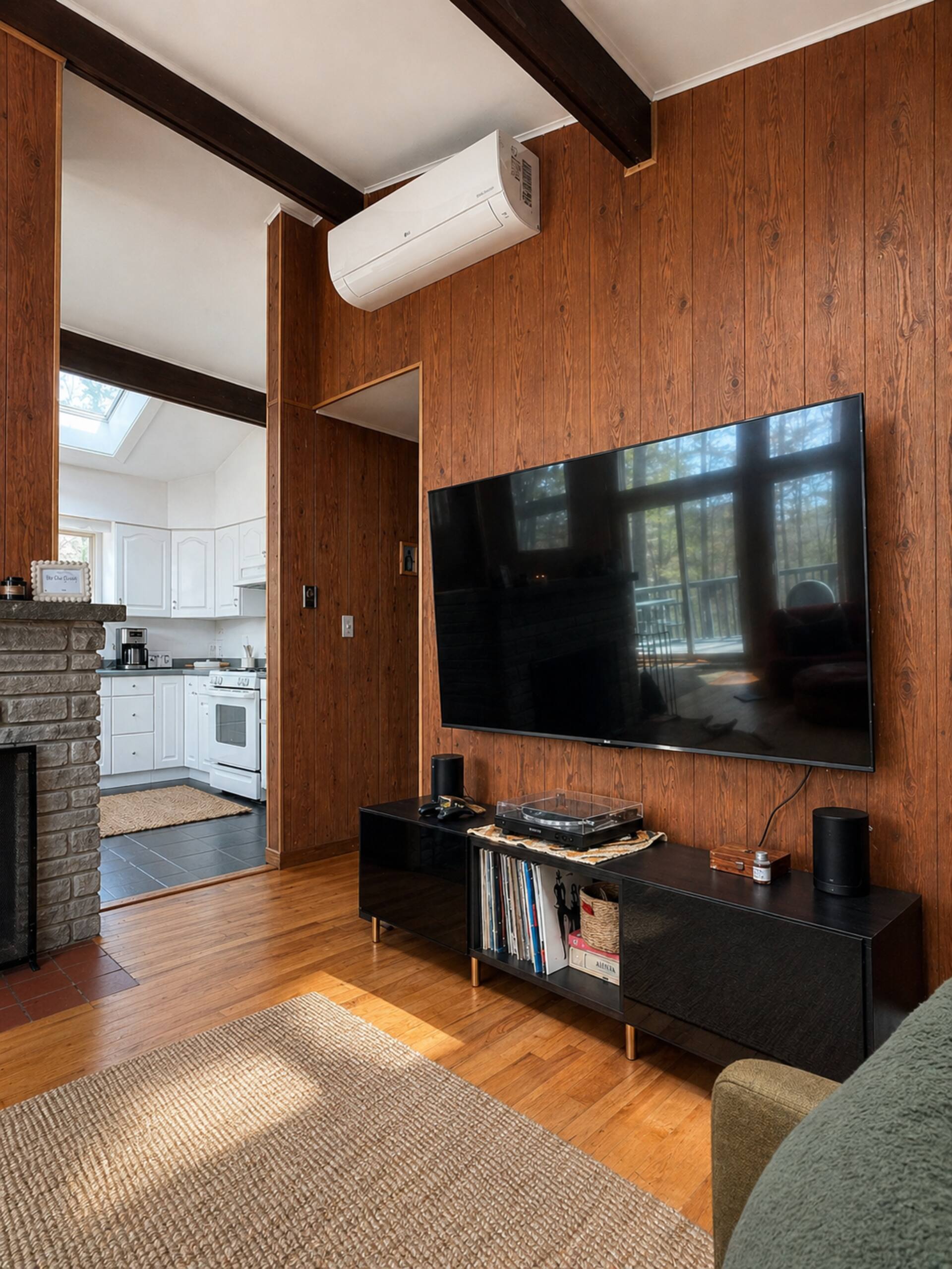 Living area with 75-inch TV and record shelf