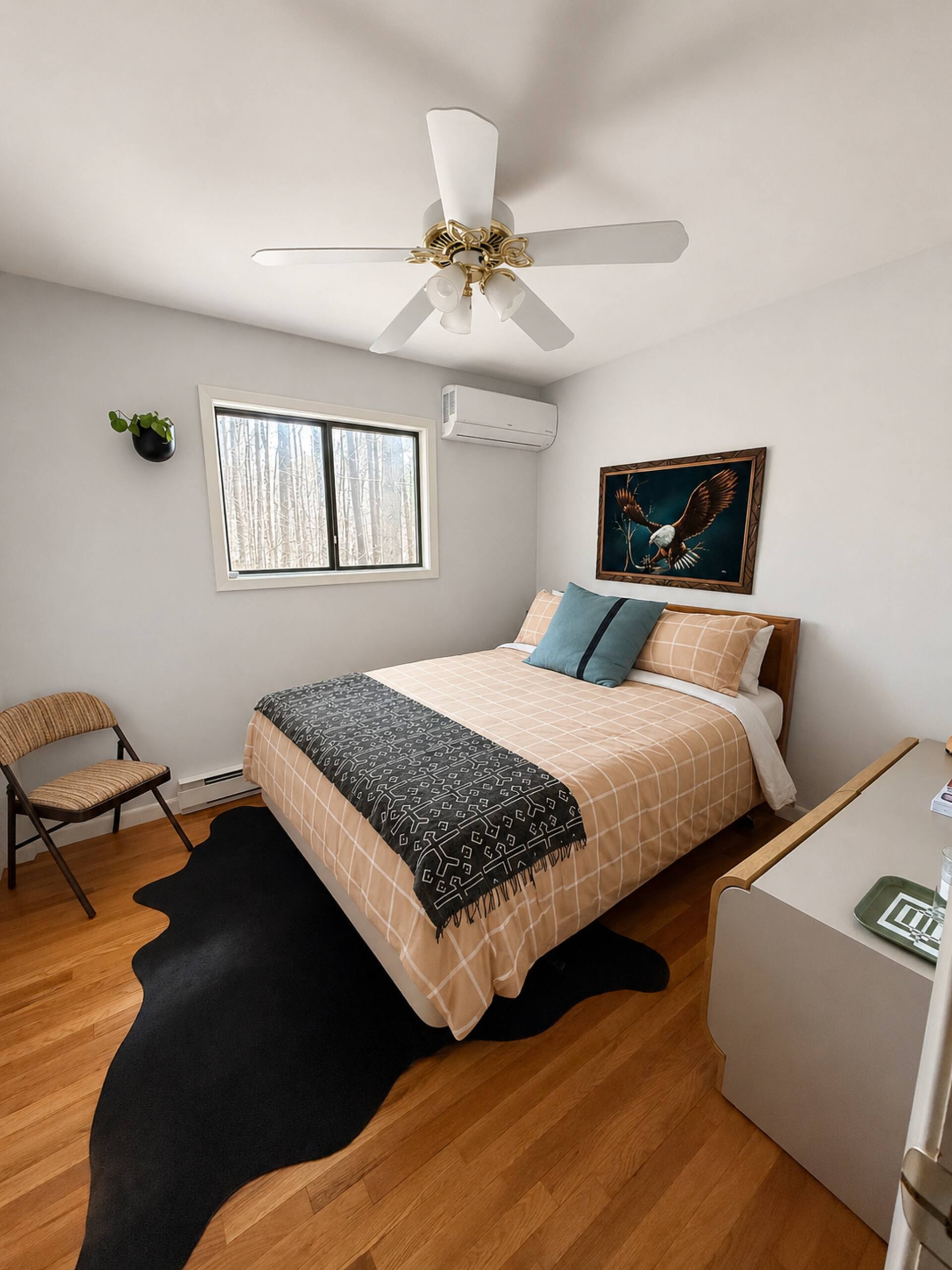 Queen bedroom with wood floors